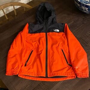 Boys North Face Orange and Black Hooded Jacket. Warm fleece lining. Waterproof.